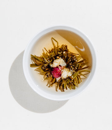 Halo Blooming Tea unfurled in glass teapot – Art of Tea